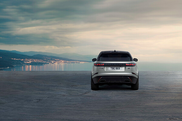 Pohled zezadu na Range Rover před mořem.